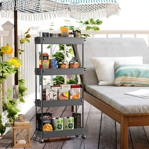A four-tier, gray utility cart with wheels is stocked with plant pots, books, and pantry items, positioned next to an outdoor lounge area.