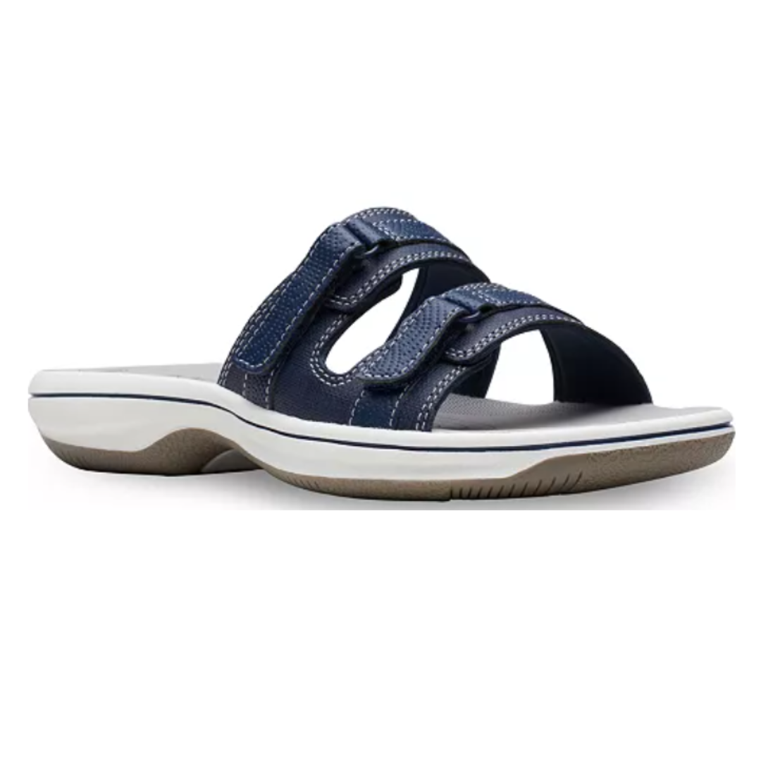 Navy blue slide sandal with two adjustable straps and a white and brown sole.