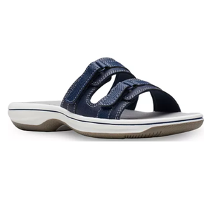 Navy blue slide sandal with two adjustable straps and a white and brown sole.