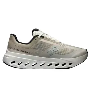 A white and beige athletic shoe with \“Swiss Engineering\“ printed on the side, featuring a unique ventilation pattern along the sole.