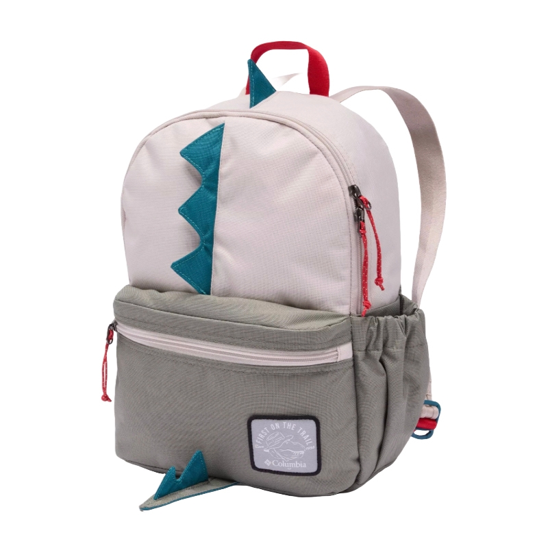 A children's backpack with a dinosaur theme, featuring green spikes on a gray and pink design, a front zippered pocket, and a patch reading \“First on the Trail\“ by Columbia.