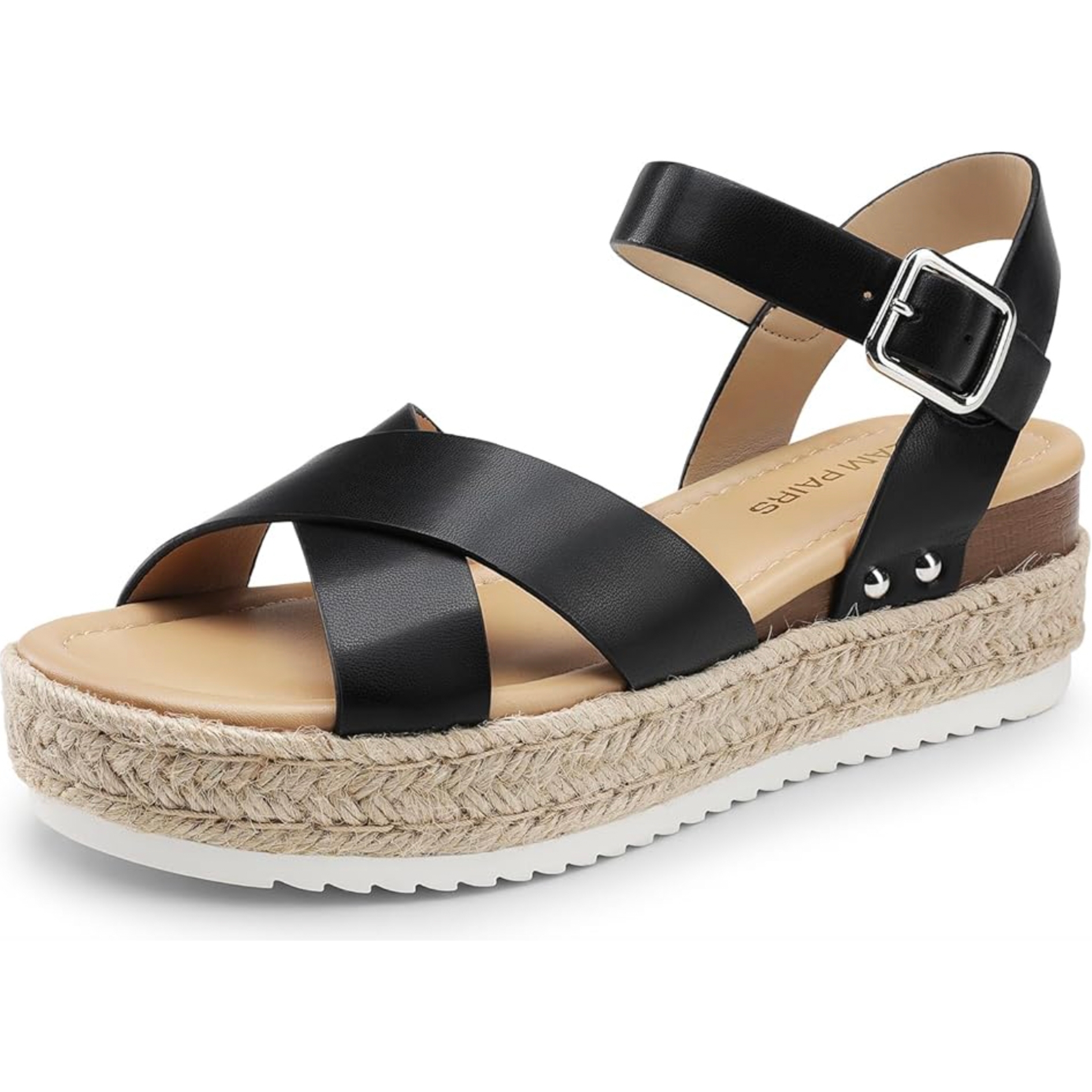 Women's espadrille wedge sandals with black leather crisscross straps, an adjustable buckle ankle strap, and a flat woven jute platform sole, featuring a white rubber outer sole for traction.