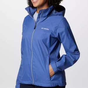 A person wearing a blue Columbia-branded hooded rain jacket.