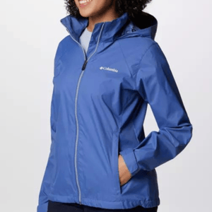 A person wearing a blue Columbia-branded hooded rain jacket.