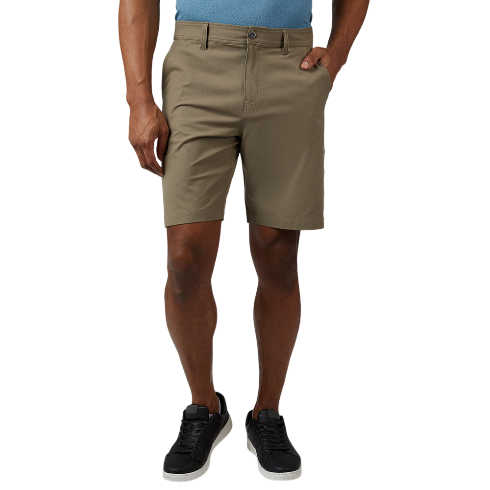 A person wearing khaki shorts paired with black sneakers and a light blue shirt.