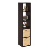 Tall, black shelving unit with five compartments, featuring decorative items, headphones, and two wicker baskets for storage.