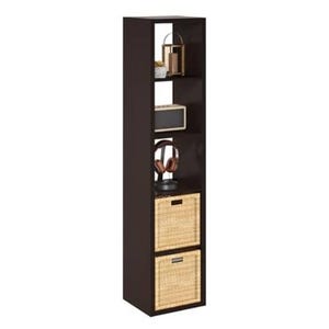 Tall, black shelving unit with five compartments, featuring decorative items, headphones, and two wicker baskets for storage.