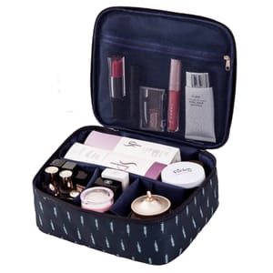 A navy blue travel cosmetics bag with various compartments holds skincare and makeup items such as lipsticks, boxed products, and jars, with a zippered mesh pocket in the lid for additional storage.