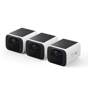 Three compact, rectangular Eufy solar security cameras with black and white casings accommodate 2K video resolution. They feature solar panels on top for power and blue indicator lights on the front.