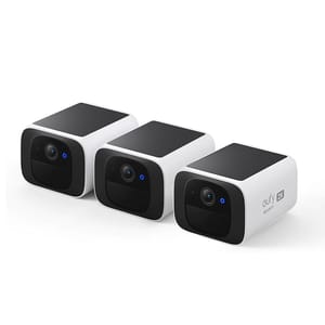 Three compact, rectangular Eufy solar security cameras with black and white casings accommodate 2K video resolution. They feature solar panels on top for power and blue indicator lights on the front.