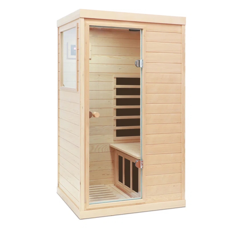A compact, wooden infrared sauna with a clear glass door and a small seating area inside.