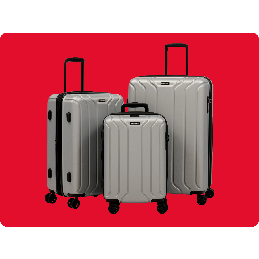 Set of three silver hard-shell suitcases with four wheels each, featuring telescopic handles, displayed against a red background.