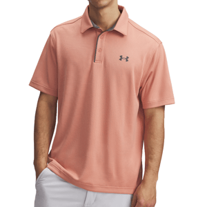 A light pink short-sleeve polo shirt featuring the Under Armour logo on the chest, paired with white pants.