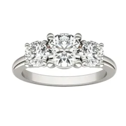 A three-stone engagement ring with a white metal band, featuring three round-cut diamonds in a classic setting.