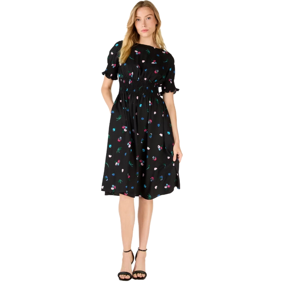A woman wearing a black floral print midi dress with short sleeves and a cinched waist, paired with black ankle-strap sandals.