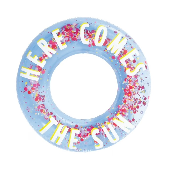 A blue inflatable pool ring featuring colorful confetti and the phrase \“HERE COMES THE SUN\“ in large, white letters with yellow shadows.