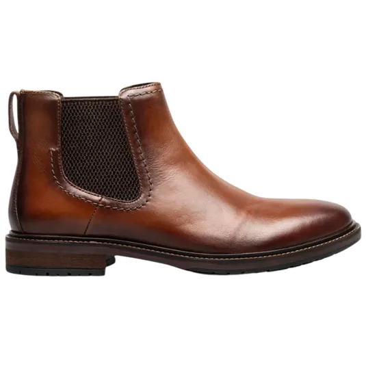 A brown leather Chelsea boot with a low heel and elastic side panels, featuring a pull tab at the back for easy wear.