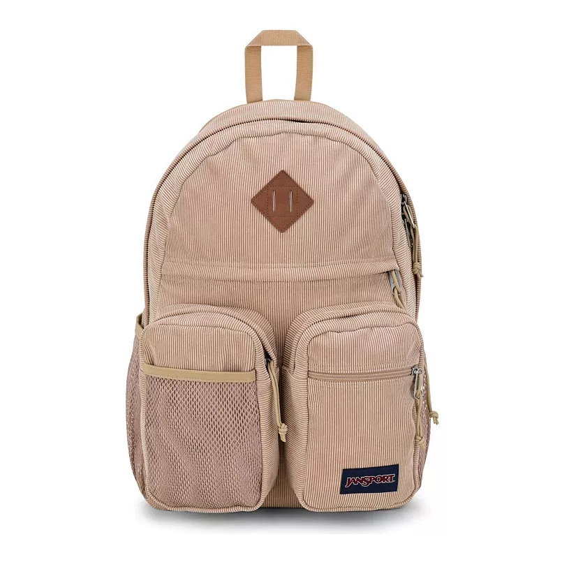The JanSport Granby Remix Backpack is a tan corduroy bag featuring multiple compartments, including two front pockets with zippers, a side mesh pocket, and a top handle. It has a simple, functional design with a leather patch detail.