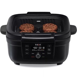 The Instant Air Fryer Grill is a black, rectangular appliance with a digital display and controls for air frying, roasting, baking, grilling, dehydrating, and reheating. It features temperature and time settings and can cook foods like burgers.