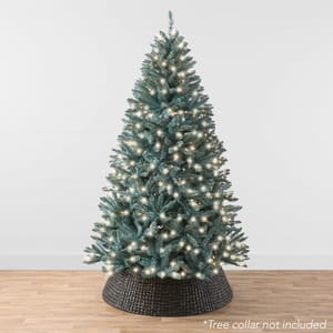 A 4.5-foot artificial Christmas tree with pre-lit white lights, lacking a tree collar, displayed on a wooden floor against a white backdrop.