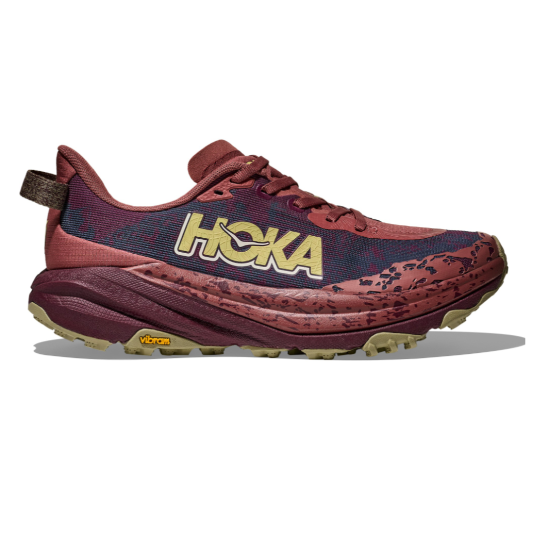 Hoka trail running shoe in a red and burgundy colorway, featuring a Vibram sole for enhanced grip and durability.