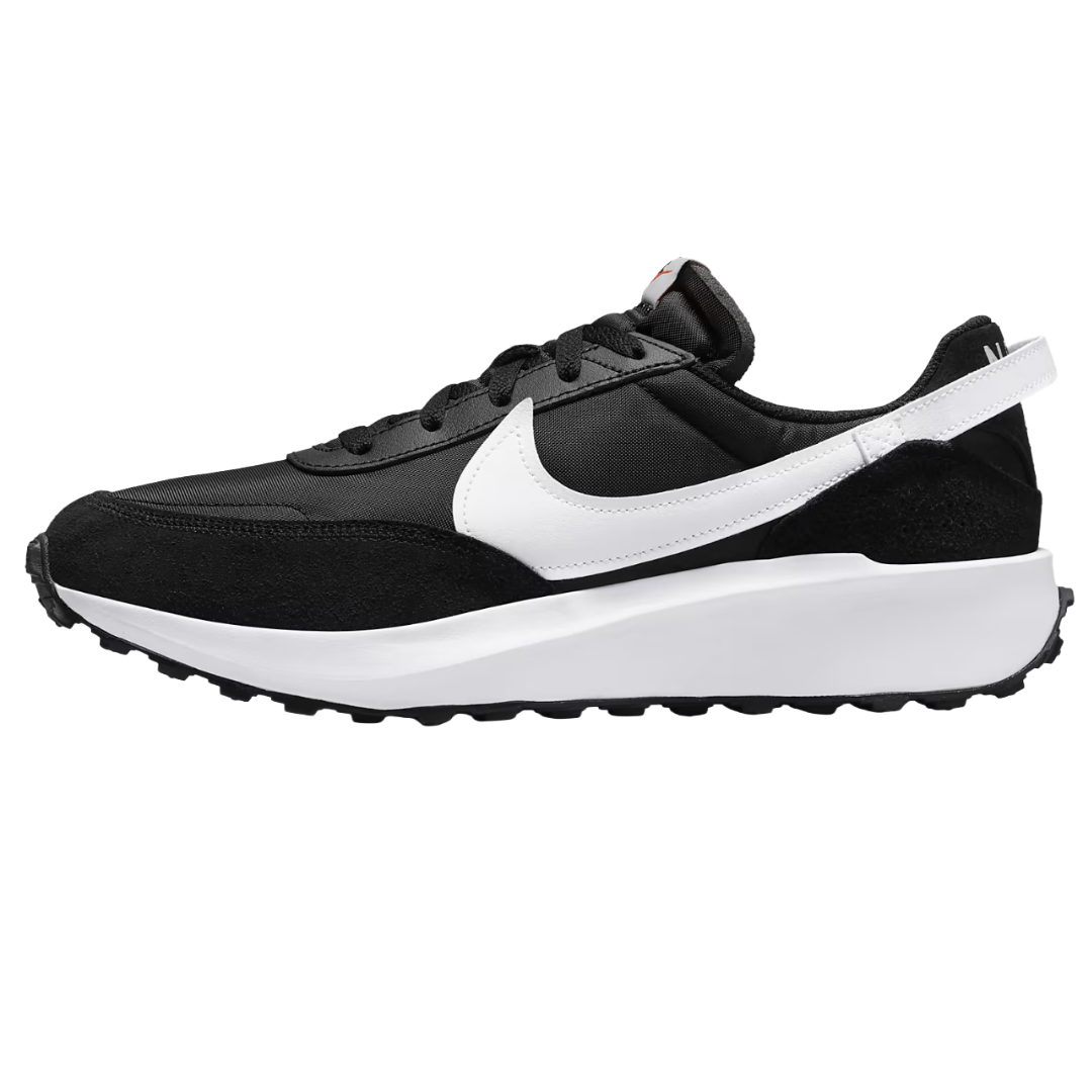 Black and white Nike sneaker with a sleek design and a prominent swoosh logo, featuring a thick white sole and black upper with suede accents.