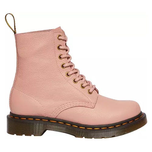 Dr. Martens 460 Pascal Boots are ankle-length lace-up boots in pink leather with signature yellow stitching and a pull-tab at the back. They feature an air-cushioned sole for comfort and durability.
