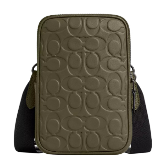 The Coach Outlet Aden Crossbody is an olive-colored, rectangular bag featuring an embossed signature pattern on the front. It has a detachable black strap and is designed for convenient, stylish carrying.