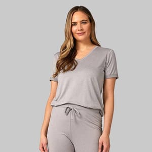 A woman wearing a gray V-neck T-shirt paired with matching drawstring pants.