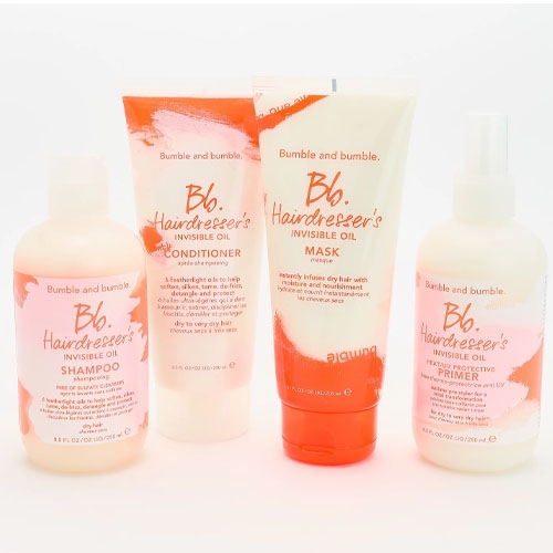 A set of Bumble and bumble Hairdresser's Invisible Oil hair care products, including shampoo, conditioner, mask, and primer.