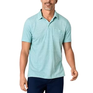 A man wears a light teal St. John's Bay Slim-Fit Polo with a subtle zigzag pattern, short sleeves, and a collar. He pairs it with dark pants, showcasing a casual yet polished look.