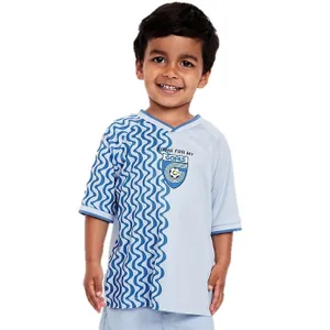 A young child is wearing a light blue athletic outfit with a wave pattern on one side of the shirt and a logo with the text \“Going for my goals.\“