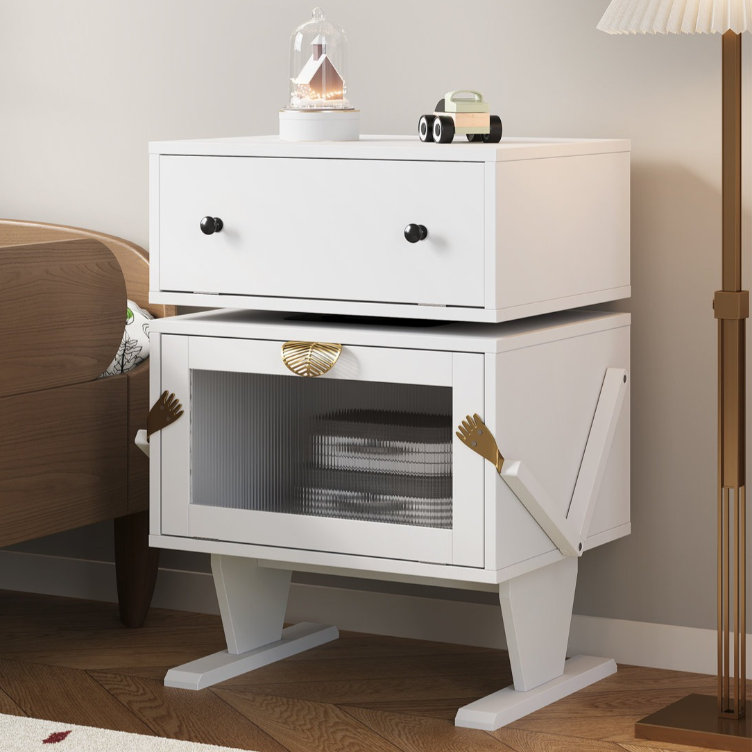 White side table with drawers and a cabinet designed with whimsical arm and leg features, featuring a decorative item and toy car on top.