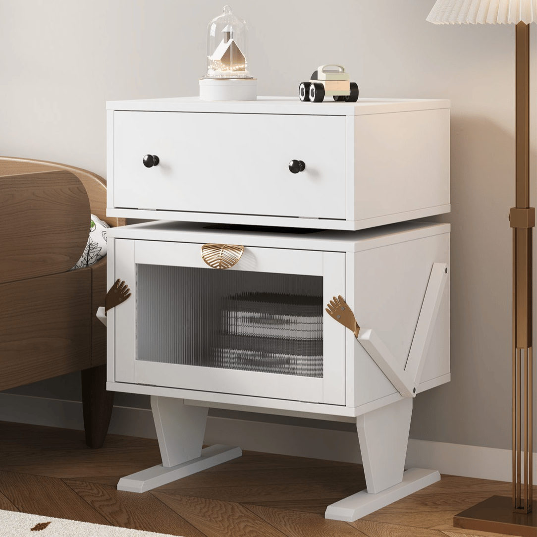 White side table with drawers and a cabinet designed with whimsical arm and leg features, featuring a decorative item and toy car on top.