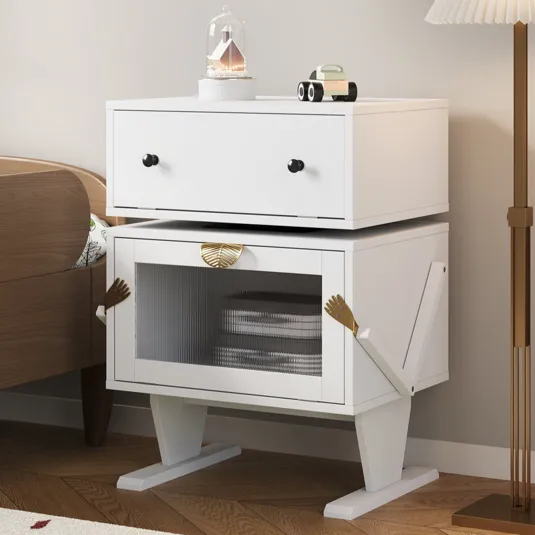 White side table with drawers and a cabinet designed with whimsical arm and leg features, featuring a decorative item and toy car on top.