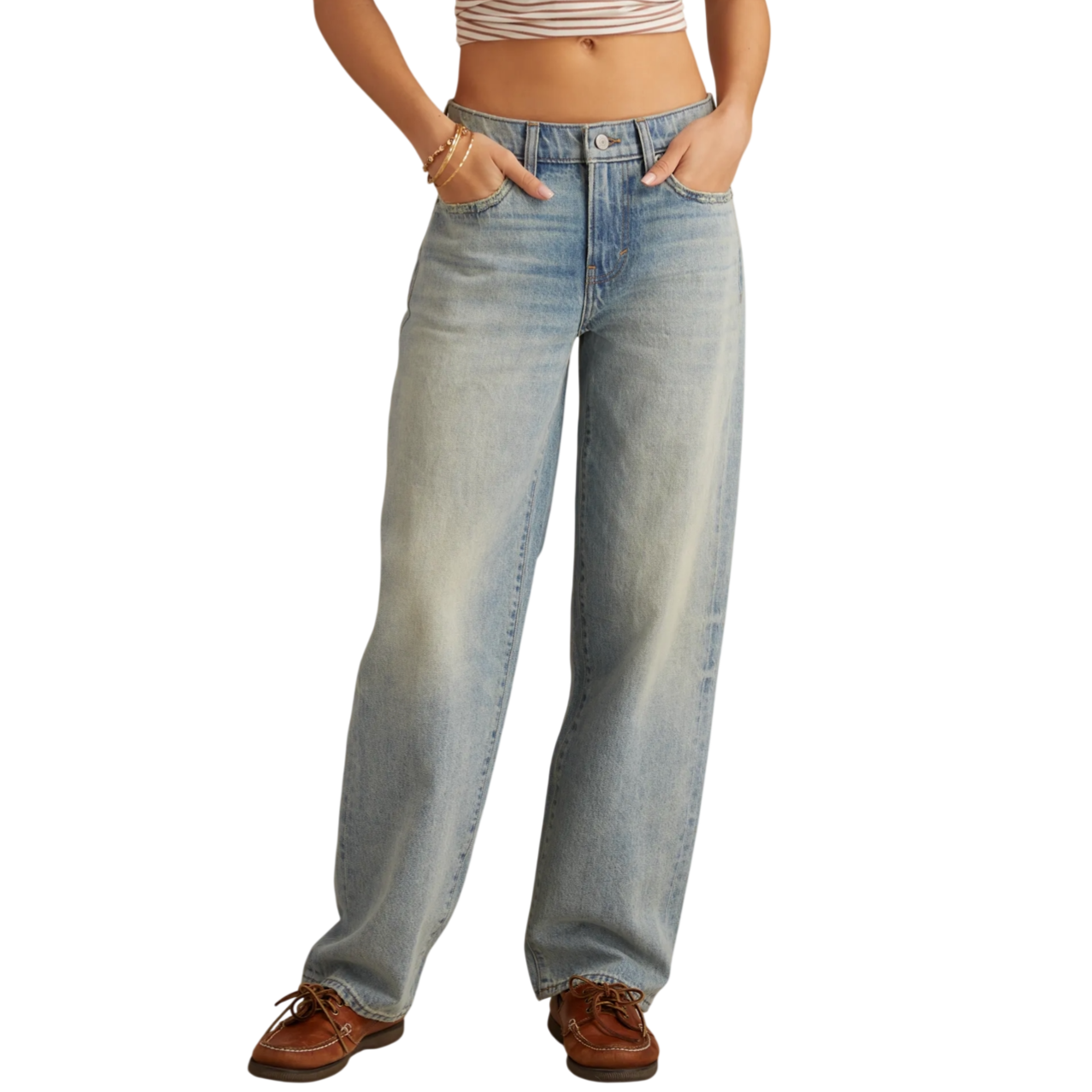 High-waisted light wash wide-leg jeans paired with brown boat shoes and a striped crop top, accented with gold bracelets.