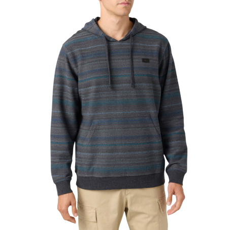 A man wearing a hooded, striped sweater with dark tones and beige cargo pants.