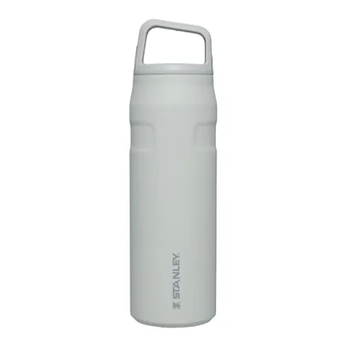 A white Stanley water bottle with a handle on the lid features a simple cylindrical design and subtle branding.