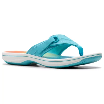 A turquoise, slip-on thong sandal with a cushioned footbed and white and turquoise sole, designed for comfort and casual wear.