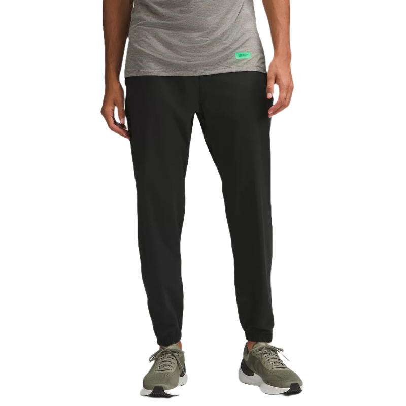 Men's joggers featuring a sleek black design, tailored fit, and comfortable fabric. Paired with olive sneakers and a gray shirt, offering a casual, athletic look.