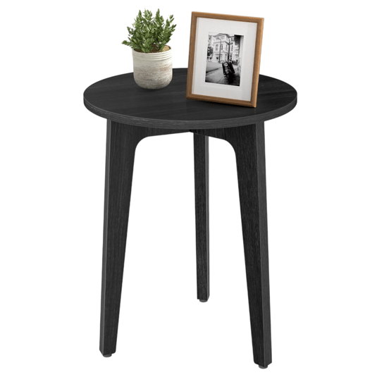 A round black wooden side table with three legs, featuring a potted plant and a framed black-and-white photo on top.