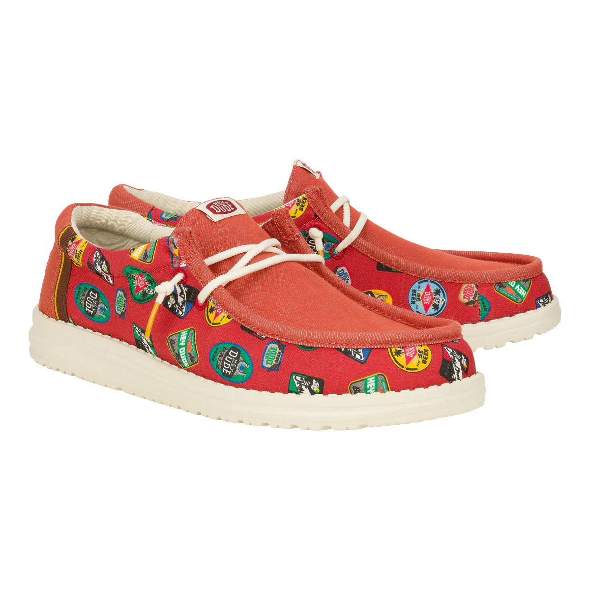 Hey Dude Wally Oktoberfest shoes feature a red canvas upper adorned with colorful beer logo graphics, white soles, and white laces.