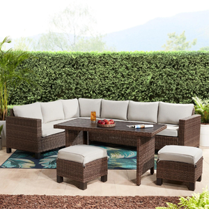 Outdoor wicker furniture set with cushions, including a sectional sofa, two ottomans, and a rectangular table.