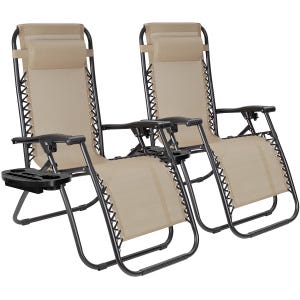 Two beige zero gravity chairs with black metal frames, adjustable headrests, and detachable side trays for holding drinks and small items.
