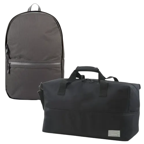 A gray backpack with a front zipper pocket and a black duffel bag with dual handles and a small label.