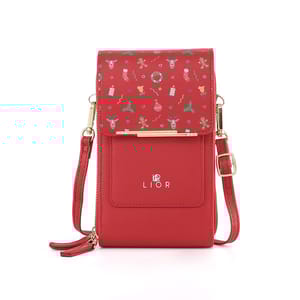 Red crossbody phone purse with festive holiday-themed patterns, gold hardware, and adjustable strap. Brand name \“LIOR\“ on front.