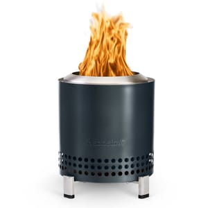 The Solo Stove Mesa XL Fire Pit is a sleek, portable fire pit with a black finish and a stainless steel rim, featuring a vented design for efficient airflow and smokeless burning. It has sturdy metal legs for stability.