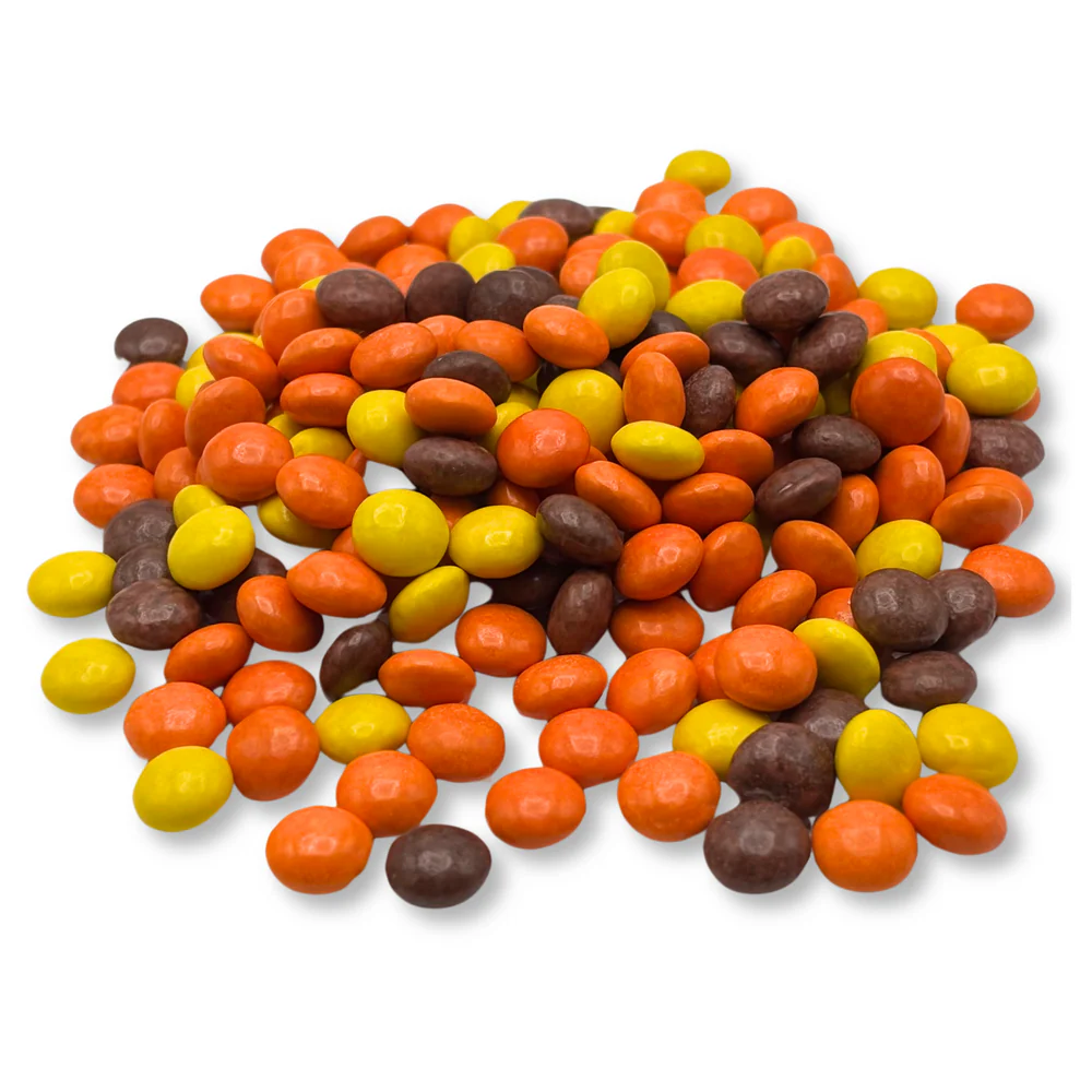 A pile of Reese's Pieces Minis in a mix of orange, yellow, and brown colors, showcasing their small, round, candy-coated shape, typical for a 5lb bag.