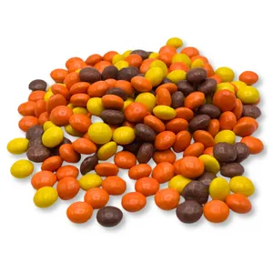 A pile of Reese's Pieces Minis in a mix of orange, yellow, and brown colors, showcasing their small, round, candy-coated shape, typical for a 5lb bag.