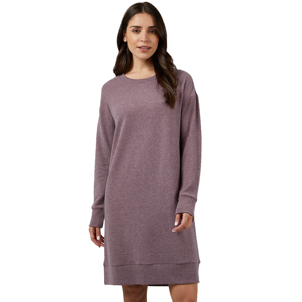 A woman is wearing a long-sleeved maroon sweater dress.